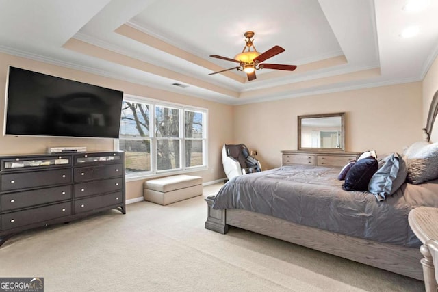 bedroom with light carpet, visible vents, baseboards, a tray ceiling, and crown molding