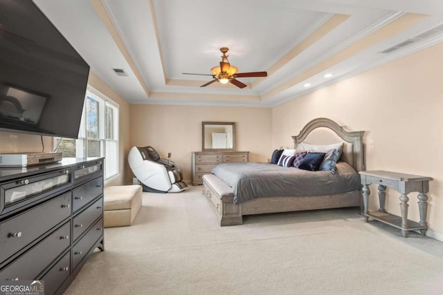 bedroom featuring visible vents, a raised ceiling, crown molding, and light colored carpet