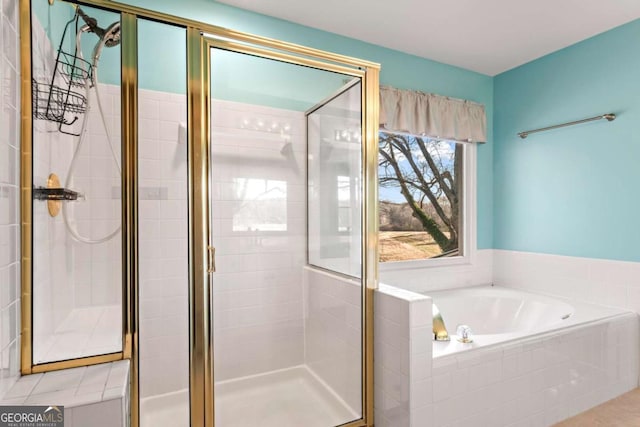 bathroom featuring a stall shower and a garden tub