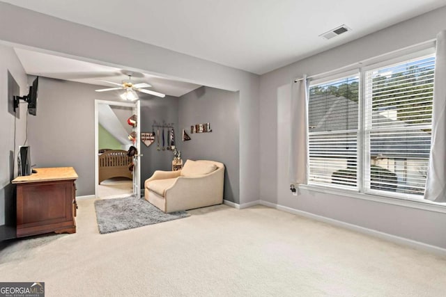 living area featuring ceiling fan, carpet, visible vents, and baseboards