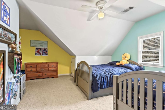 bedroom featuring a ceiling fan, light colored carpet, visible vents, and lofted ceiling