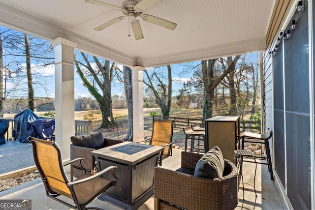 exterior space with ceiling fan and a fire pit