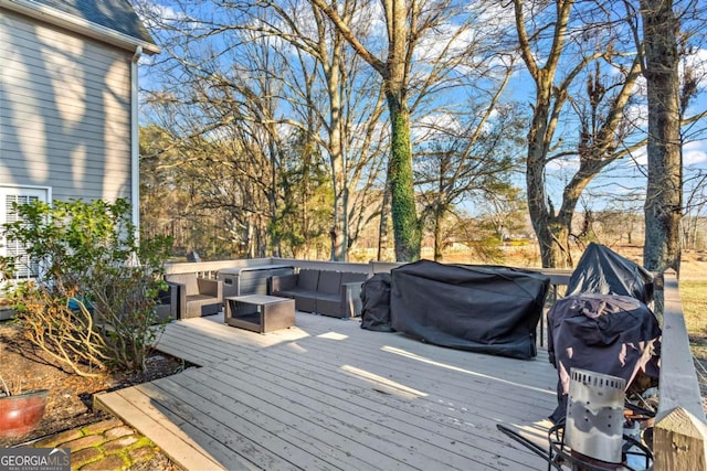 wooden deck featuring grilling area and an outdoor living space