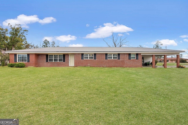 ranch-style house with metal roof, a carport, brick siding, and a front yard