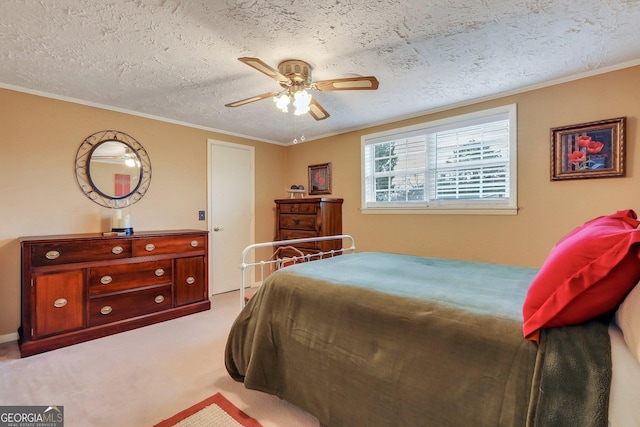 bedroom with light carpet, ceiling fan, a textured ceiling, and crown molding