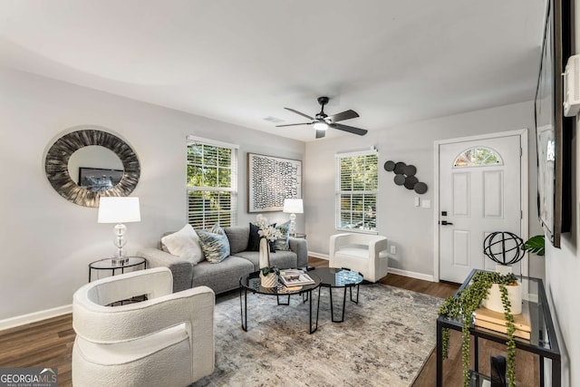 living area featuring a healthy amount of sunlight, baseboards, and wood finished floors