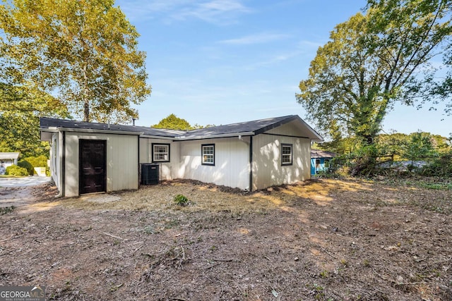 back of house featuring central AC