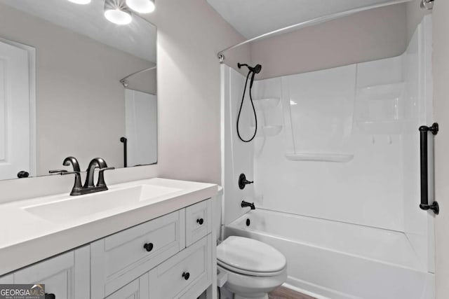 bathroom with toilet, bathing tub / shower combination, and vanity