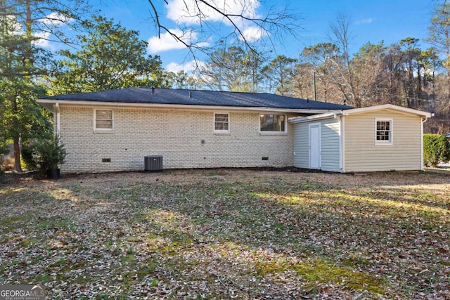 back of property featuring central AC, brick siding, and crawl space