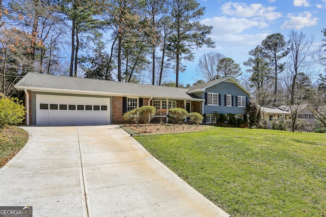 split level home with an attached garage, a front yard, concrete driveway, and brick siding