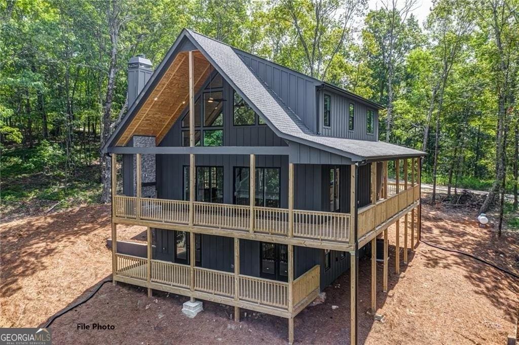 1365 Hunter Dr, Ranger, GA 30734 - rear view of property featuring a shingled roof, board and batten siding, a chimney, and view of scattered trees