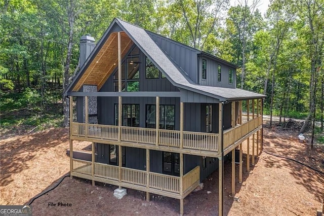 1365 Hunter Dr, Ranger, GA 30734 - rear view of property featuring a shingled roof, board and batten siding, a chimney, and view of scattered trees