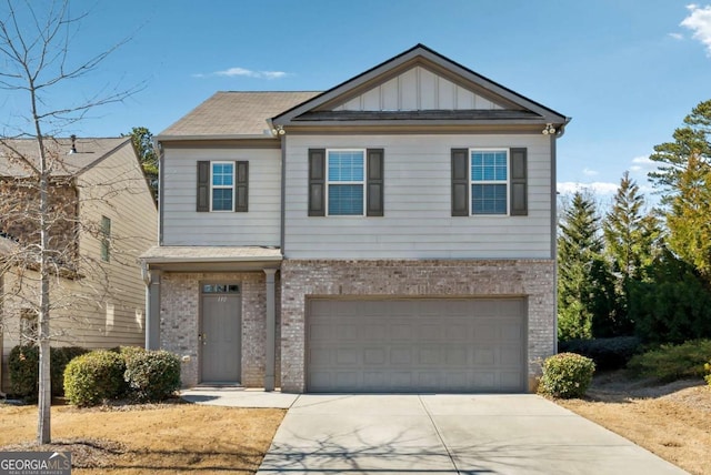 view of front of home featuring board and batten siding, brick siding, driveway, and an attached garage