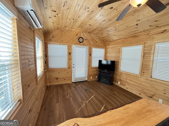 unfurnished living room with wood walls, wood finished floors, wood ceiling, vaulted ceiling, and a wall mounted air conditioner