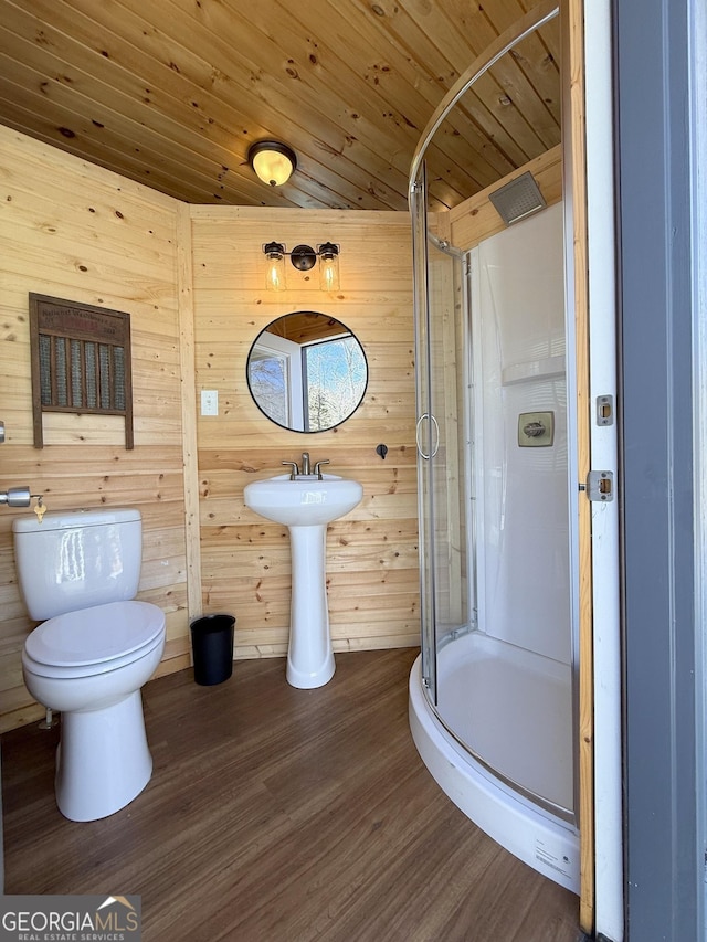 bathroom featuring a stall shower, wooden ceiling, wood finished floors, and toilet