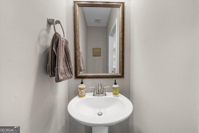bathroom with visible vents and a sink