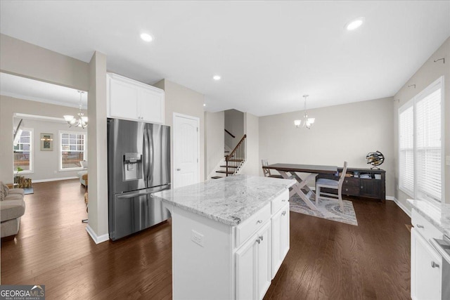kitchen with white cabinets, a notable chandelier, stainless steel fridge, and dark wood-style flooring