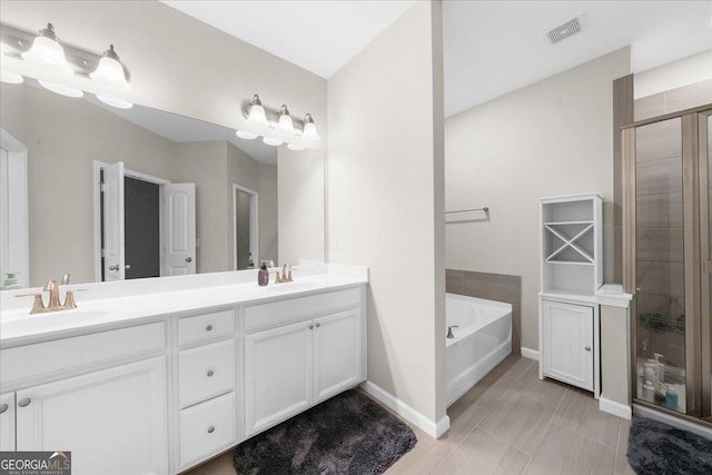 bathroom featuring a sink, visible vents, a bath, and double vanity