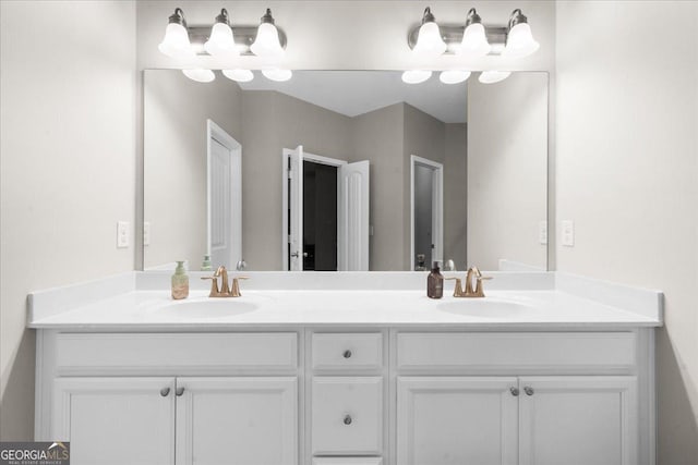 full bath with a sink and double vanity