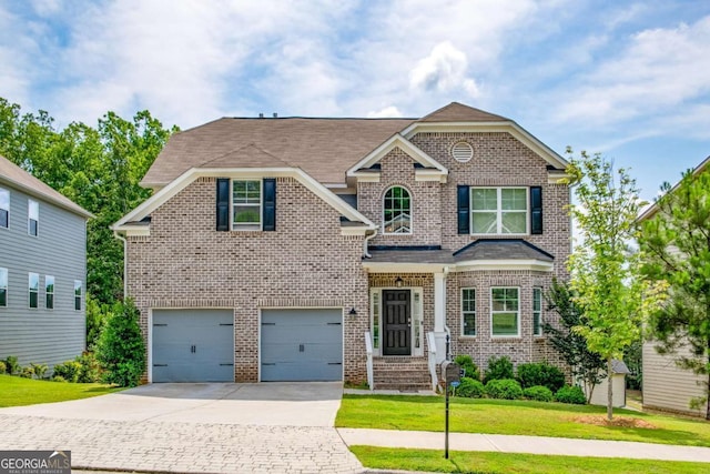 view of front of home with an attached garage, a front yard, concrete driveway, and brick siding