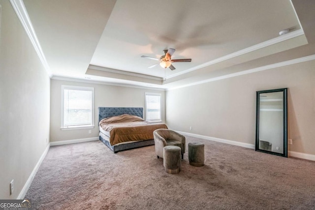 bedroom with carpet flooring, a raised ceiling, multiple windows, and baseboards