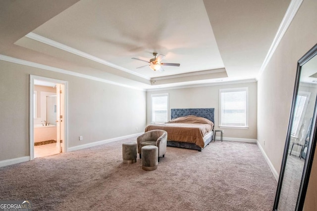 bedroom with baseboards, a tray ceiling, crown molding, and light colored carpet