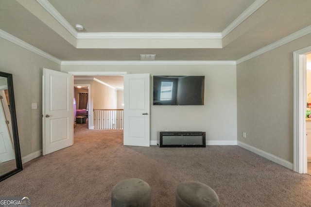 interior space featuring a tray ceiling, light colored carpet, crown molding, and baseboards