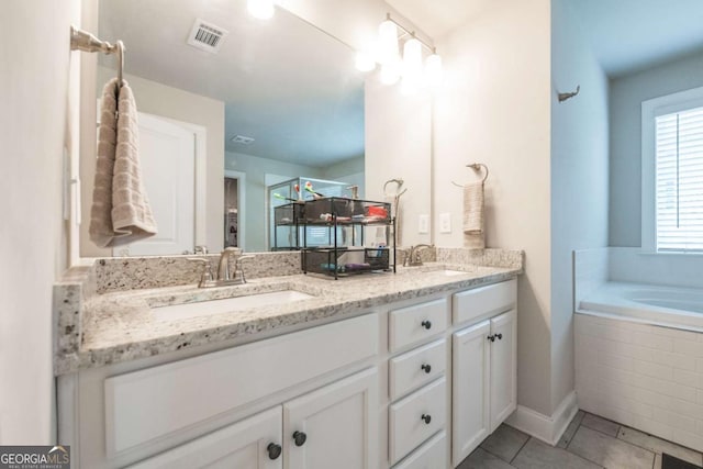 full bath featuring double vanity, tile patterned flooring, a sink, and visible vents