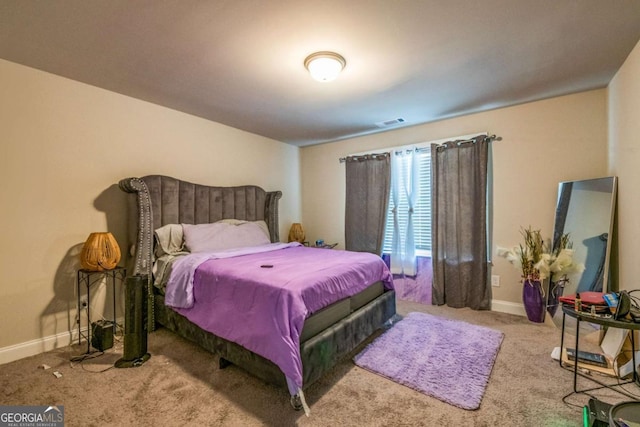 carpeted bedroom featuring visible vents and baseboards