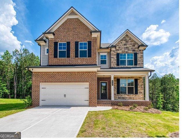 view of front facade featuring brick siding, an attached garage, stone siding, driveway, and a front lawn