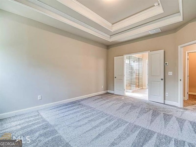 unfurnished bedroom featuring carpet floors, baseboards, a raised ceiling, and crown molding