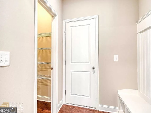 mudroom featuring baseboards and wood finished floors