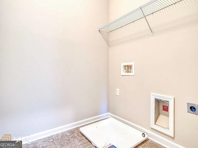 clothes washing area with laundry area, washer hookup, electric dryer hookup, and baseboards