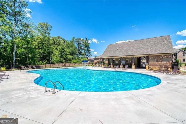 pool featuring a patio area and fence