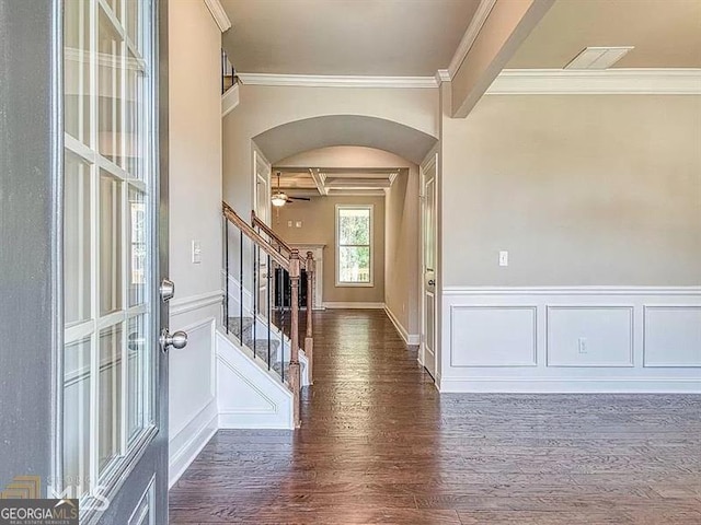 entryway featuring arched walkways, visible vents, wood finished floors, beamed ceiling, and stairs