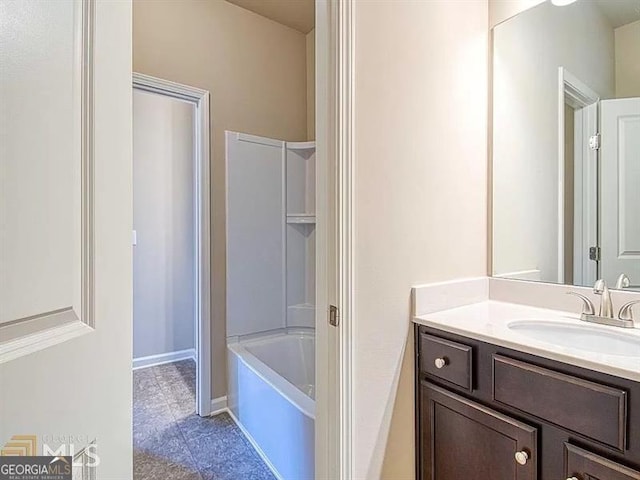 bathroom featuring baseboards and vanity