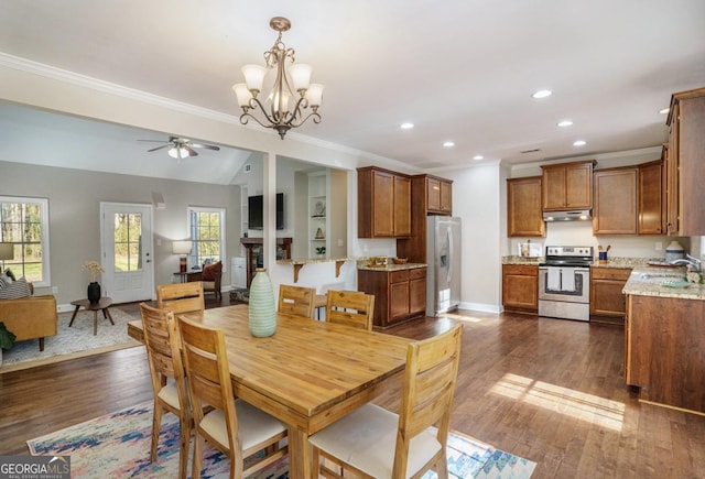 dining area featuring a fireplace, dark wood finished floors, recessed lighting, ornamental molding, and baseboards