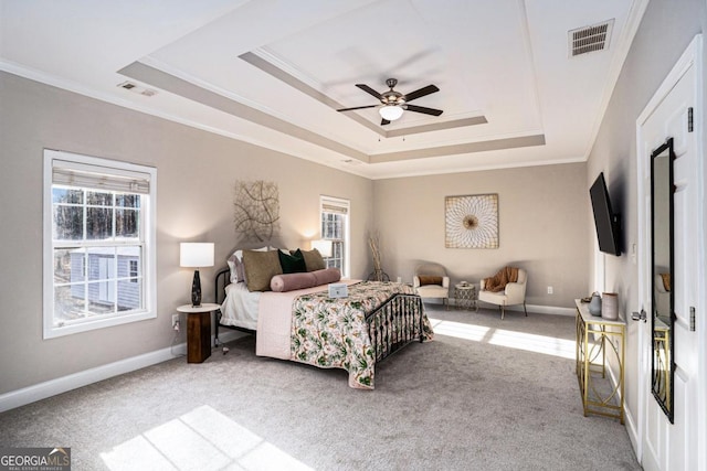 bedroom with crown molding, visible vents, a raised ceiling, and carpet flooring