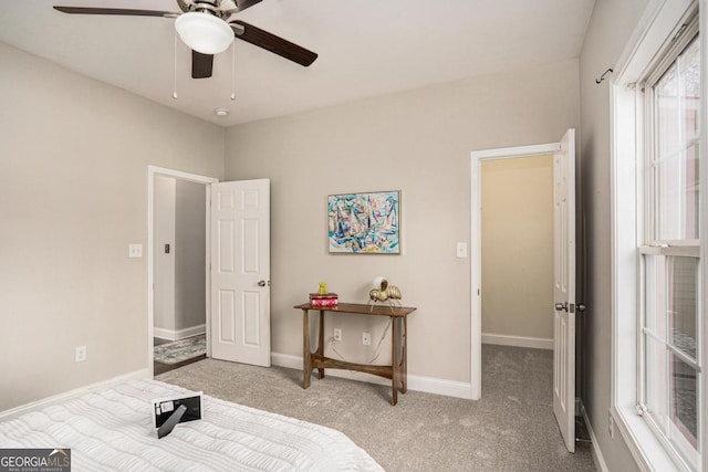 carpeted bedroom featuring ceiling fan and baseboards