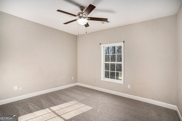 empty room with a ceiling fan, carpet flooring, and baseboards