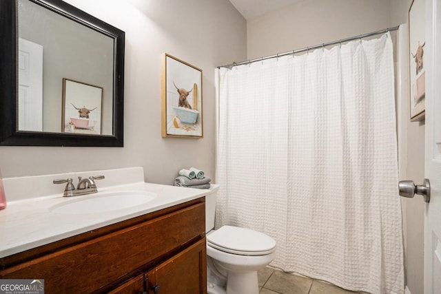 bathroom featuring toilet, tile patterned flooring, and vanity