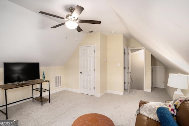 interior space featuring lofted ceiling, carpet floors, visible vents, and baseboards