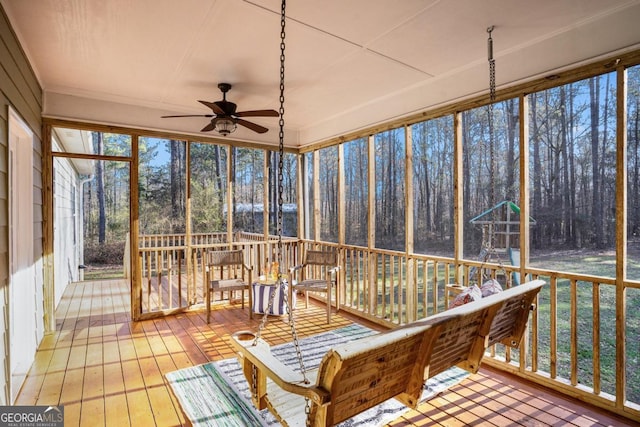 sunroom / solarium featuring ceiling fan