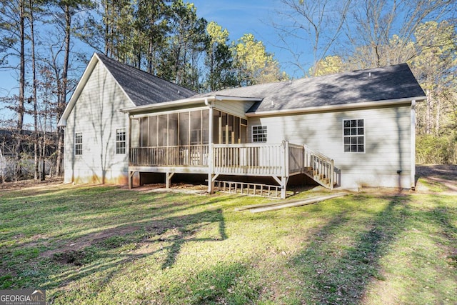 back of property with a sunroom and a yard