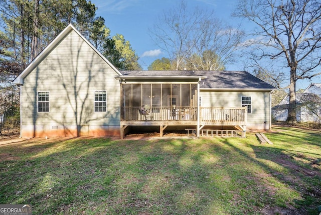 rear view of property featuring a sunroom and a lawn