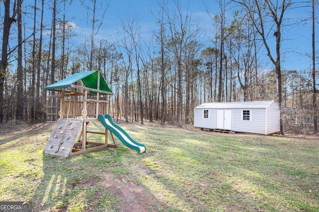 view of yard with an outbuilding, a storage shed, and a playground