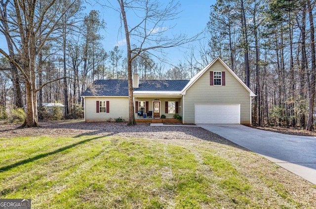 view of front of house with a porch, a garage, driveway, and a front lawn