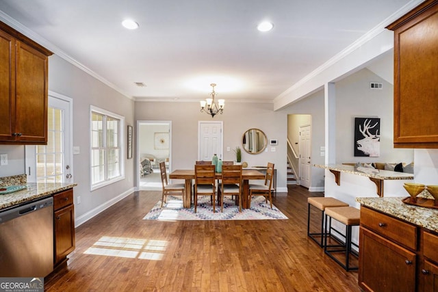 dining room with dark wood-style flooring, visible vents, stairway, ornamental molding, and a chandelier