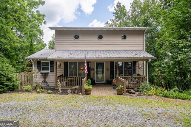 view of front of home with a porch and metal roof