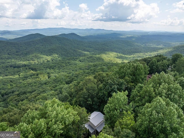 aerial view with a mountain view and a wooded view